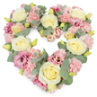 A full, heart-shaped funeral wreath is shown against a bright white background, the delicate arrangement of pastel flowers conveying a gentle, comforting mood. The heart is completely filled with tightly packed blooms, dominated by creamy yellow and ivory roses whose layered petals create rounded, elegant focal points across the design. Interwoven among these roses are generous clusters of light pink carnations, their frilled petals giving a soft, almost feathery texture that blurs the boundaries between each flower and adds to the wreath's sense of tenderness. Richer notes come from magenta and mauve-pink lisianthus blossoms, their slightly fluted, open forms adding variety in shape and depth of colour, reminiscent of the soft evening light over Harold Wood's residential streets. Cool, silvery-green eucalyptus leaves curl and loop throughout, their rounded forms and muted tone creating a calm backdrop that outlines the heart's curves and brings visual balance. Small yellowish-green buds appear between the larger blooms, catching the eye and hinting at the freshness of flowers prepared the same day at a local Harold Wood florist. The dense, carefully layered placement of every stem results in a wreath that feels complete and supportive, with no empty spaces-only overlapping petals and foliage that seem to hold one another up. This heart speaks of enduring love, quiet sorrow, and cherished memories, ideal for resting beside a casket, on a stand at a memorial service, or on a graveside in and around Harold Wood, offering a dignified and compassionate floral tribute when families need it most.